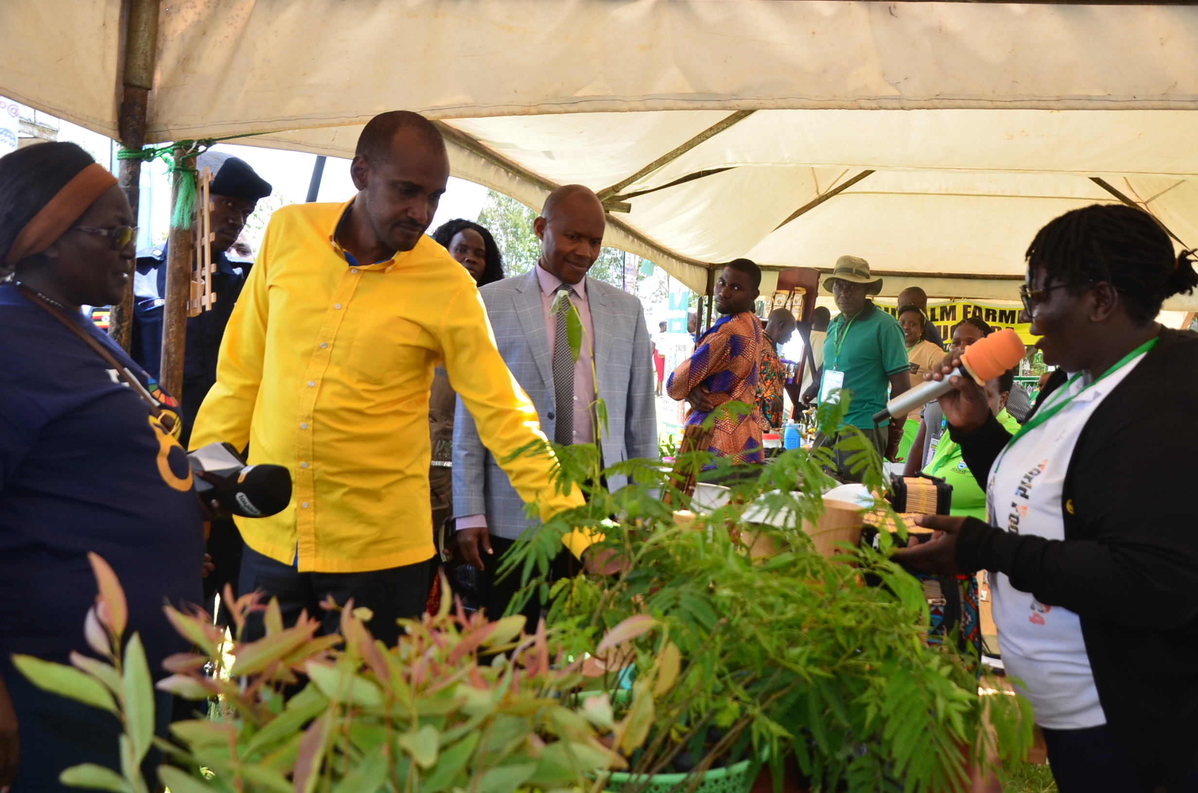 Frank-Tumwebaze-in-yellow-inspects-the-stalls-at-celebrations.